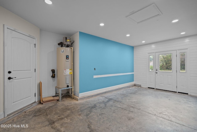 entrance foyer with electric water heater, recessed lighting, baseboards, and concrete floors