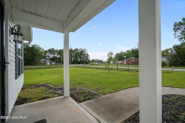 view of green lawn featuring a patio area