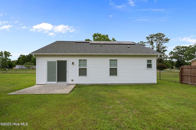 rear view of property featuring a patio area and a shingled roof