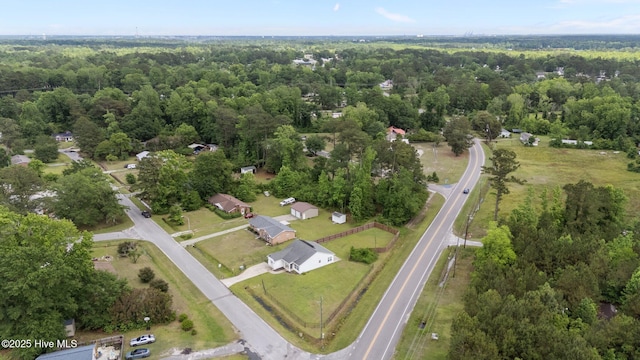 view of property location with a forest