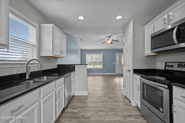 kitchen featuring stainless steel appliances, a sink, ceiling fan, white cabinets, and recessed lighting