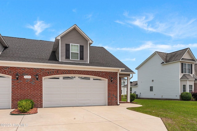 view of front of property with brick siding, a front yard, concrete driveway, and a shingled roof