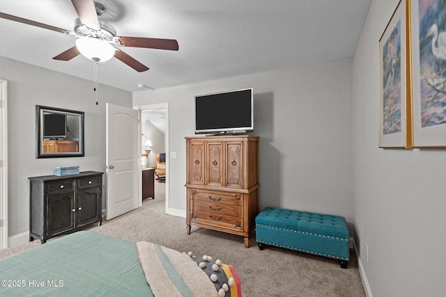 bedroom with light colored carpet and baseboards