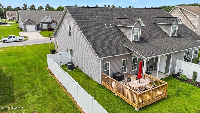 back of property featuring a shingled roof, a deck, and cooling unit