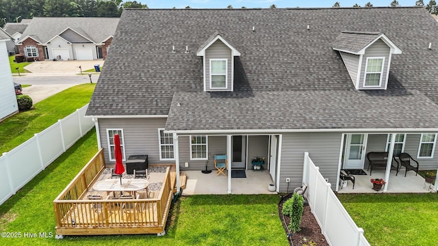 rear view of property with a shingled roof, a wooden deck, and a patio area