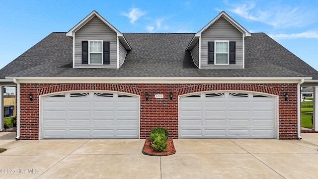 view of front of property with brick siding, roof with shingles, and concrete driveway