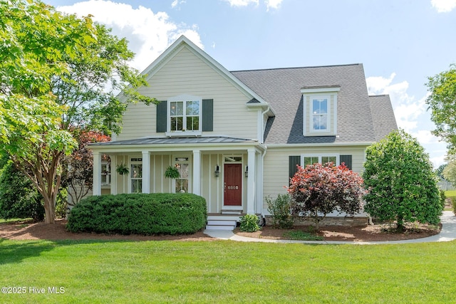 view of front of home featuring a front yard, roof with shingles, a porch, and a standing seam roof
