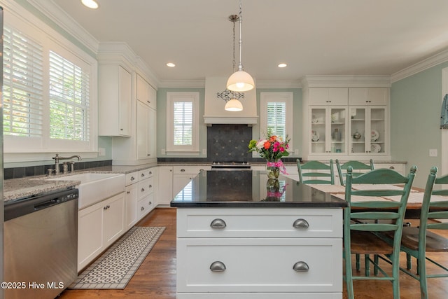 kitchen with dishwasher, white cabinets, ornamental molding, a kitchen island, and recessed lighting