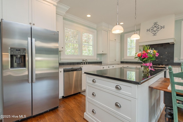 kitchen featuring appliances with stainless steel finishes, ornamental molding, dark wood-style floors, white cabinetry, and recessed lighting