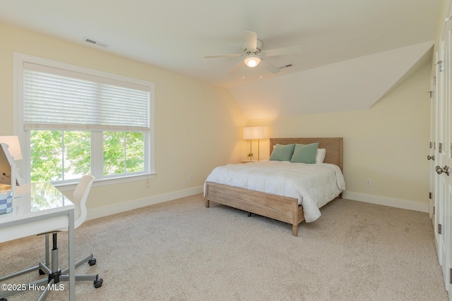 bedroom with carpet flooring, baseboards, vaulted ceiling, and a ceiling fan