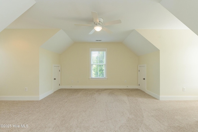 bonus room featuring carpet floors, lofted ceiling, a ceiling fan, and baseboards