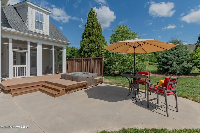 view of patio / terrace with a hot tub and a sunroom