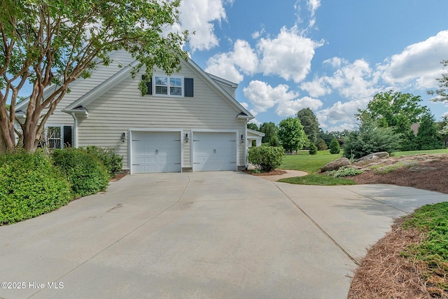 view of home's exterior with driveway and a garage