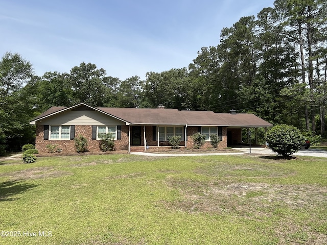 ranch-style house with an attached carport, brick siding, and a front yard