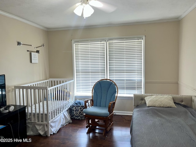 bedroom with wood finished floors, ornamental molding, and ceiling fan