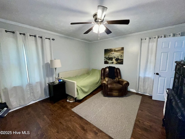 bedroom with dark wood-style floors, crown molding, and a ceiling fan