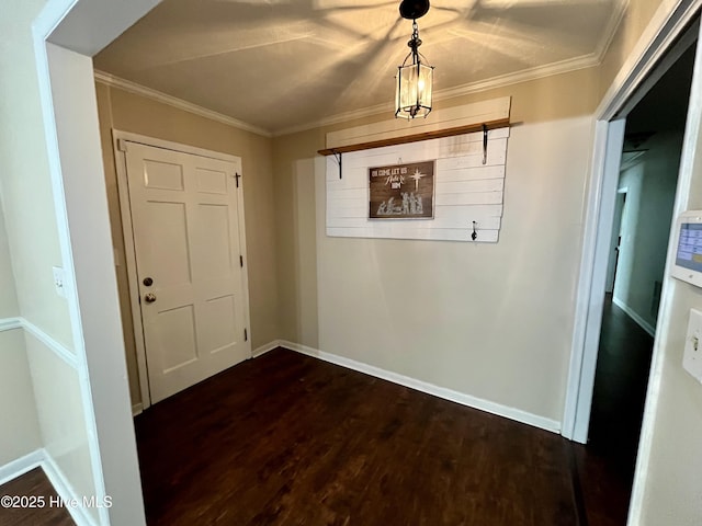 corridor with dark wood-type flooring, crown molding, and baseboards