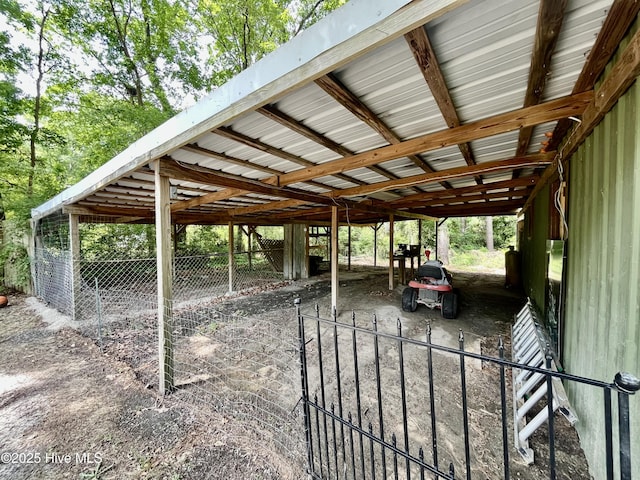 view of vehicle parking with a carport and an exterior structure