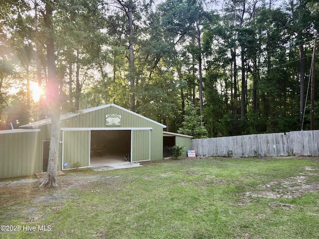view of yard featuring an outbuilding and a garage