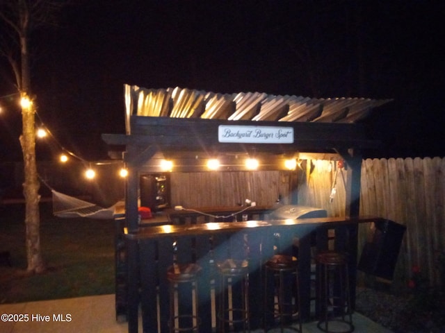 patio at night featuring fence