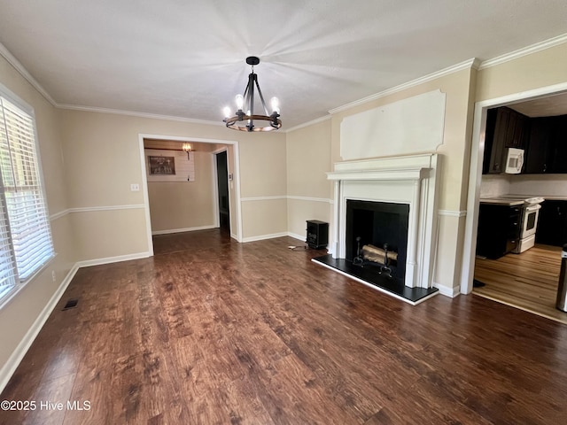 unfurnished living room with a chandelier, dark wood-style floors, crown molding, baseboards, and a fireplace with raised hearth