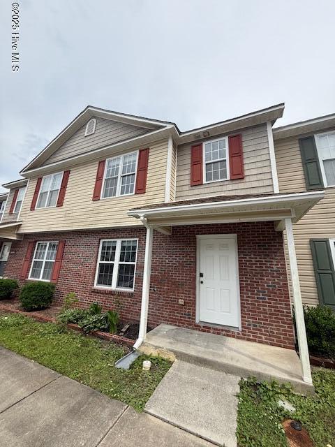 townhome / multi-family property featuring brick siding