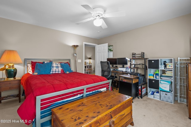 carpeted bedroom with a desk and ceiling fan