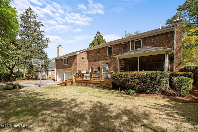 6212 Turtle Hall Dr, Wilmington, NC 28409 - rear view of property with a chimney, a garage, brick siding, and a lawn