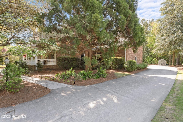 view of front of property with brick siding and driveway