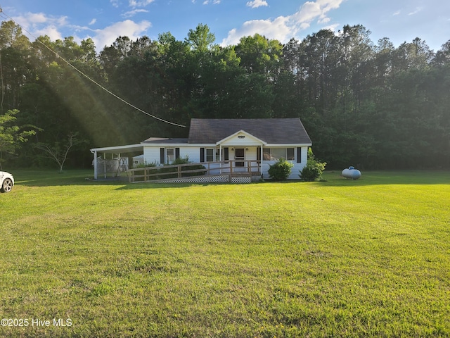 113 Publo Rd, South Mills, NC 27976 - view of front facade with a deck, a front yard, and a view of trees