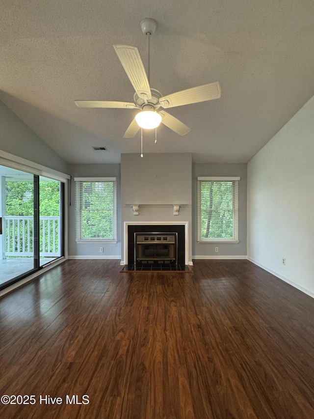 126 W Victoria Ct Unit D, Greenville, NC 27834 - unfurnished living room with wood finished floors, a textured ceiling, lofted ceiling, ceiling fan, and baseboards