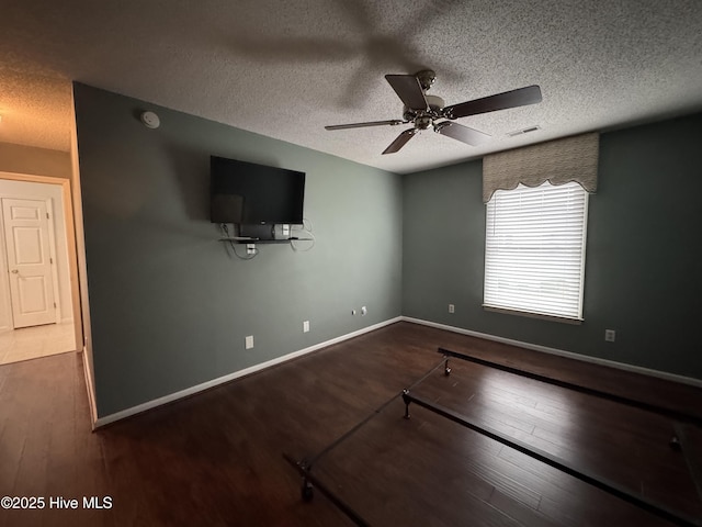 126 W Victoria Ct Unit D, Greenville, NC 27834 - unfurnished living room featuring wood finished floors, a ceiling fan, a textured ceiling, and baseboards