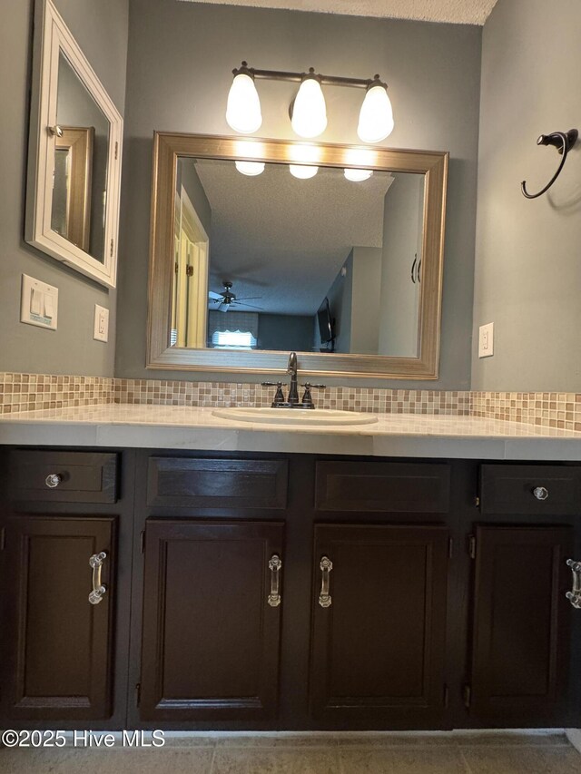 126 W Victoria Ct Unit D, Greenville, NC 27834 - bathroom with decorative backsplash, vanity, and a ceiling fan