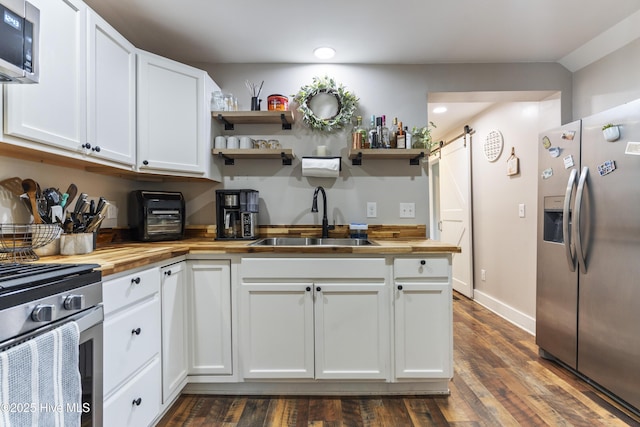 102 E 9th St, Washington, NC 27889 - kitchen with appliances with stainless steel finishes, butcher block countertops, a sink, open shelves, and recessed lighting
