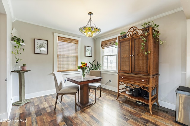 102 E 9th St, Washington, NC 27889 - dining room with dark wood-style floors, ornamental molding, and baseboards