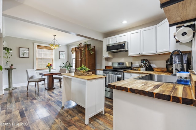 102 E 9th St, Washington, NC 27889 - kitchen featuring wood counters, appliances with stainless steel finishes, a sink, recessed lighting, and white cabinetry