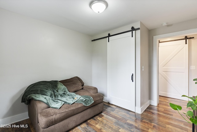102 E 9th St, Washington, NC 27889 - sitting room with a barn door, baseboards, and wood finished floors