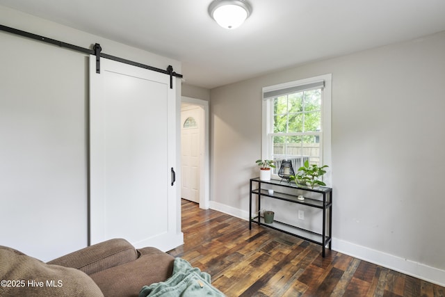 102 E 9th St, Washington, NC 27889 - living area with a barn door, hardwood / wood-style floors, and baseboards