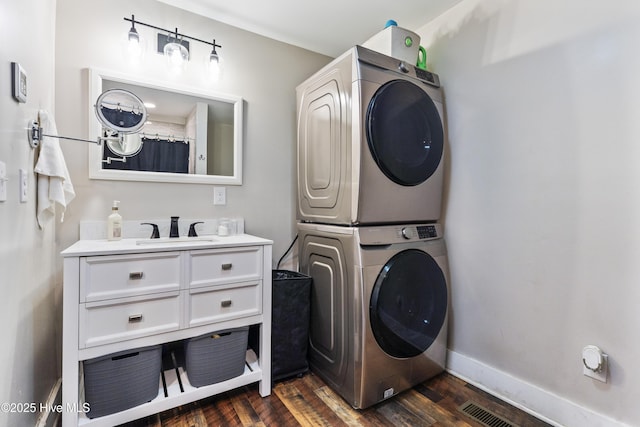 102 E 9th St, Washington, NC 27889 - washroom featuring estacked washer and dryer, dark wood-style floors, and baseboards