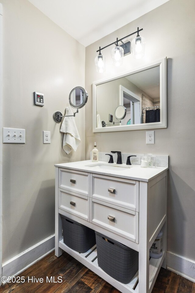 102 E 9th St, Washington, NC 27889 - bathroom featuring baseboards, wood finished floors, and vanity