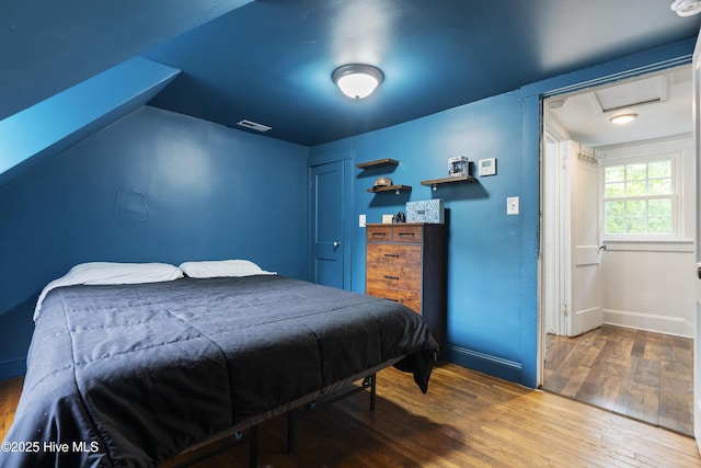 102 E 9th St, Washington, NC 27889 - bedroom with attic access, wood finished floors, and baseboards