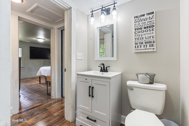 102 E 9th St, Washington, NC 27889 - bathroom with hardwood / wood-style floors, vanity, and toilet