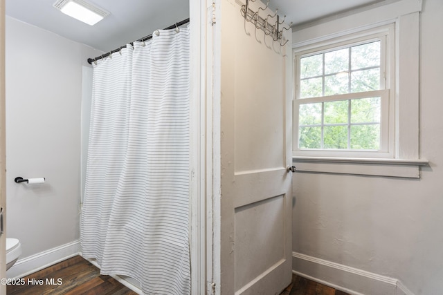 102 E 9th St, Washington, NC 27889 - full bath with baseboards, toilet, wood finished floors, and curtained shower