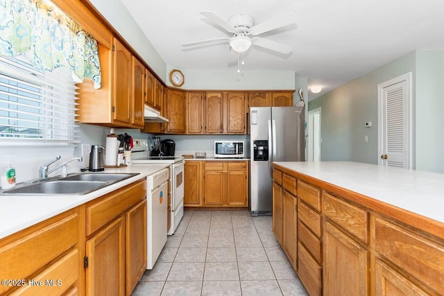 6301 Ocean Dr, Emerald Isle, NC 28594 - kitchen with stainless steel appliances, under cabinet range hood, a sink, light countertops, and ceiling fan