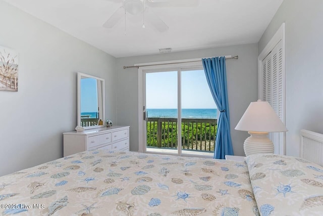 6301 Ocean Dr, Emerald Isle, NC 28594 - bedroom with access to exterior, a water view, and a ceiling fan