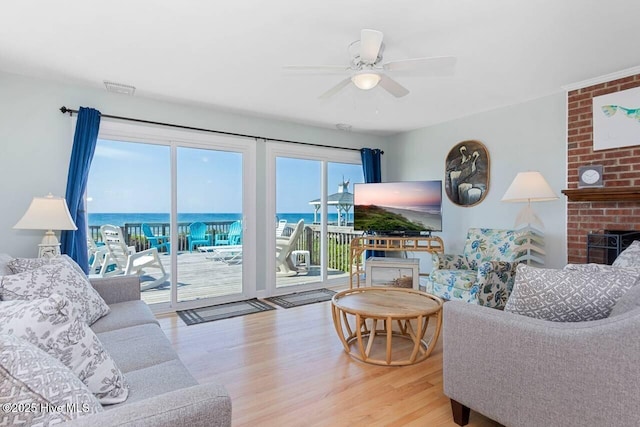 6301 Ocean Dr, Emerald Isle, NC 28594 - living area featuring wood finished floors, ceiling fan, and a brick fireplace