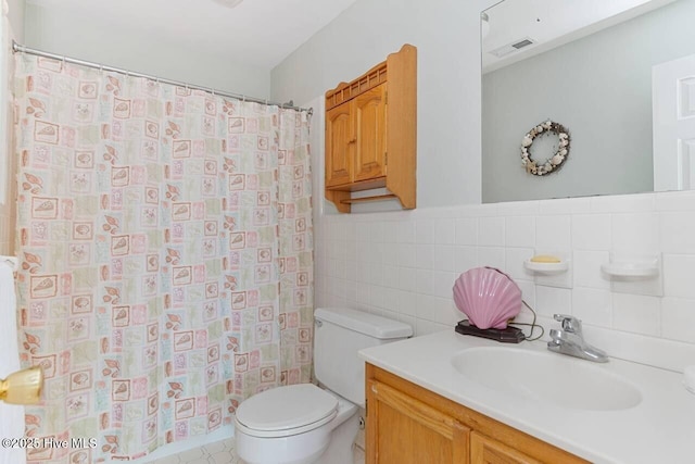 6301 Ocean Dr, Emerald Isle, NC 28594 - full bathroom featuring tile walls, toilet, vanity, and a shower with curtain