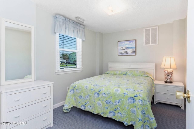 6301 Ocean Dr, Emerald Isle, NC 28594 - bedroom featuring dark carpet, baseboards, and a textured ceiling