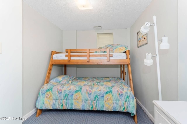 6301 Ocean Dr, Emerald Isle, NC 28594 - bedroom with carpet floors, a textured ceiling, and baseboards