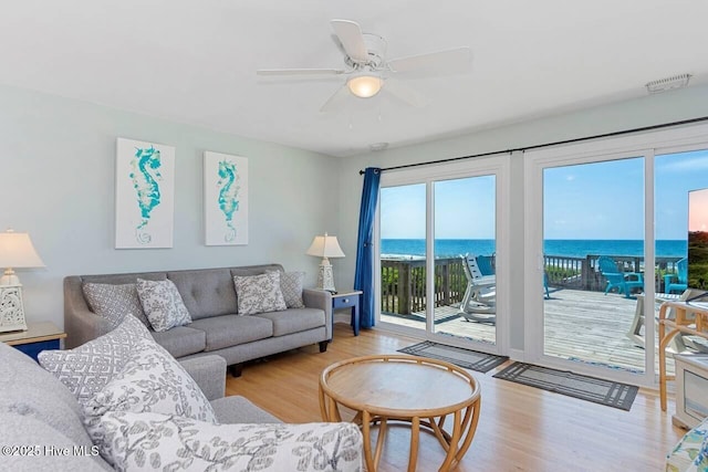6301 Ocean Dr, Emerald Isle, NC 28594 - living room with wood finished floors, a ceiling fan, and a water view